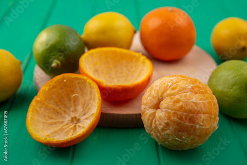 front view fresh sliced orange and lemon on dark background ripe mellow fruit juice color citrus tree citrus, Whole and sliced ripe oranges placed on marble background, half orange and lemon fruit.