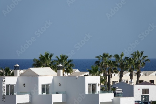 High-angle of white apartments near the sea, clear sky background