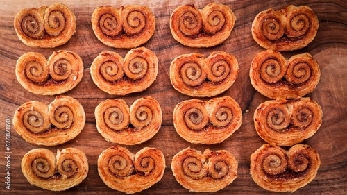 Closeup top view of crusty Cinnamon sugar palmiers on a wooden surface