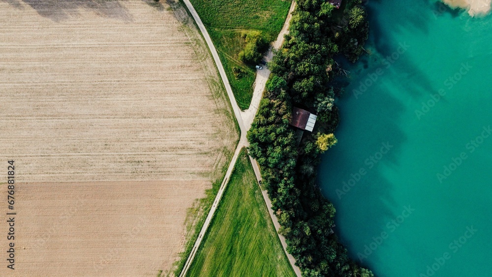 Aerial view of a beautiful lake near a field