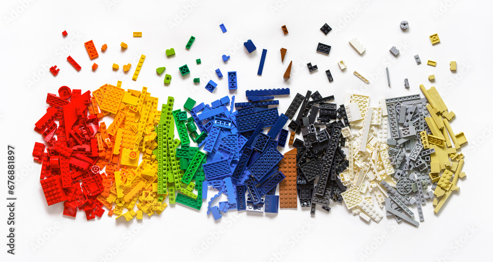 Obraz premium Pile of colorful rainbow toy bricks isolated on white background. Education concept. Lego blocks. Novosibirsk, Russia - October 26, 2023.