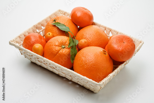 Orange fruit with green leaves on the white wood. Home gardening. Mandarine oranges. Tangerine oranges. Orange color. Fresh orange juice, Mandarin Oranges Slice Flatlay on a Marble Background.