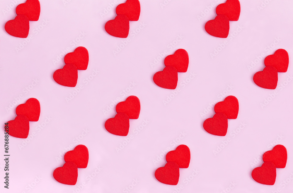Background for Valentine's day. Red hearts on the pink background. Flay lay. Pattern.