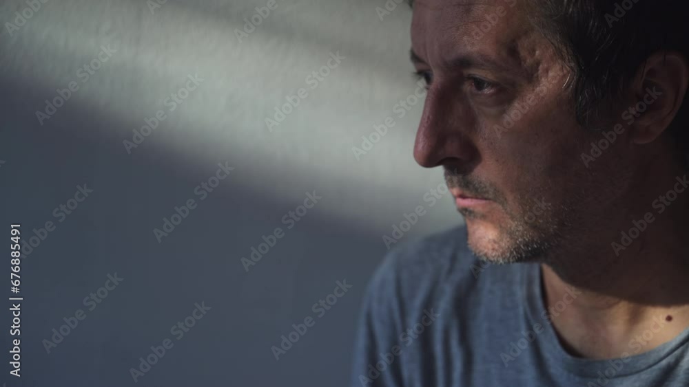 Adult caucasian male looking out through the window and thinking Adult caucasian male looking out through the window and thinking