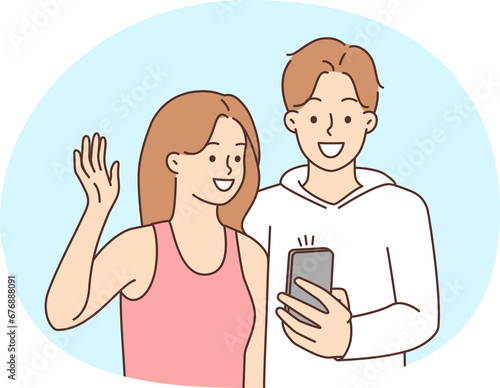 Smiling couple talking on video call on cell