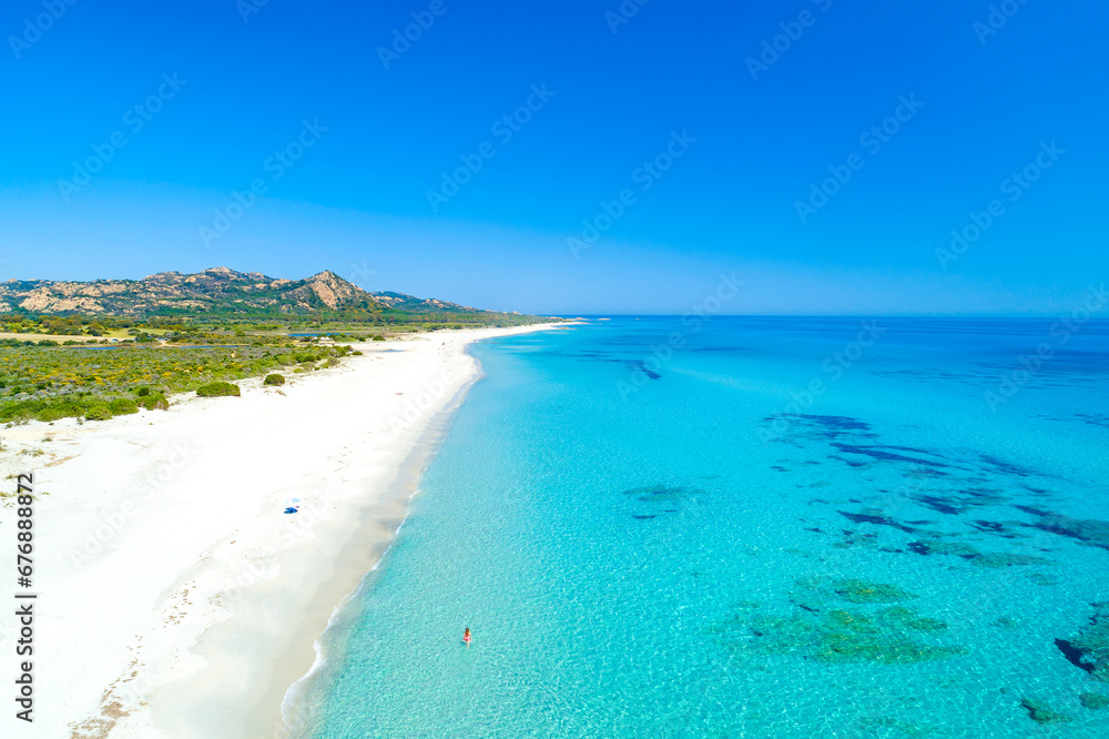 Italy, Sardinia, Golfo di Orosei, Siniscola, woman walking in the sea at Berchida beach