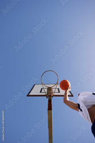Man, basketball and low angle shot for point as jump athlete, game challenge or sky mockup. Male person, hand and string dunk score at hoop for exercise fun or fitness training sport, player on court