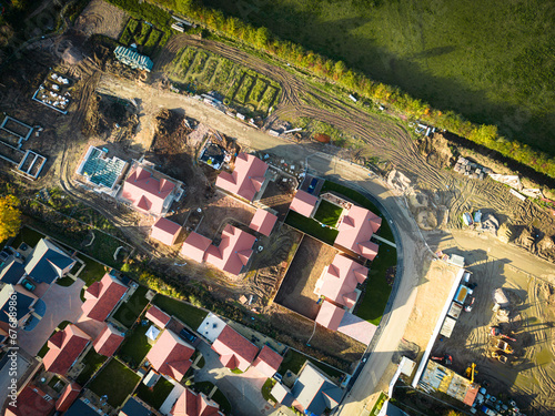 Drone top down view of private and affordable housing in development in East Anglia, UK. Some bungalows are seen sold and lived in. photo