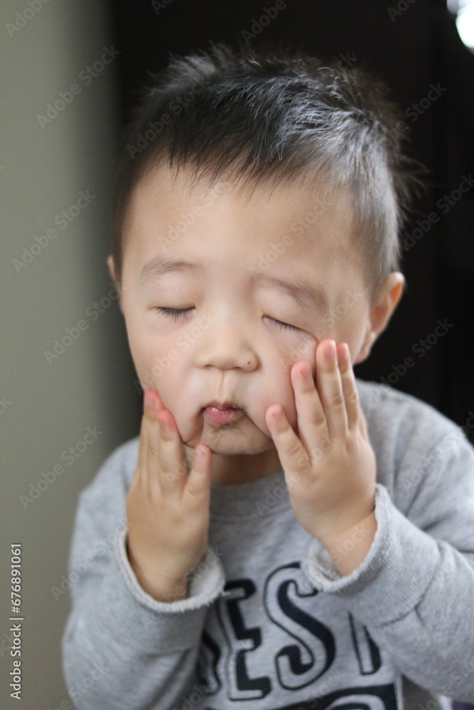 A child's face reflects despair, disbelief and a plea for cessation. Asian boy's face reflects disbelief and saying A child's face reflects despair, disbelief and a plea for cessation. Asian boy's face reflects disbelief and saying
