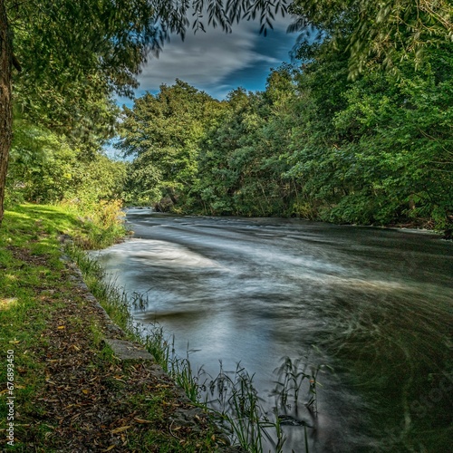 Beautiful view of flowing river Doon passing through the Ayrshire village of Dalrymple near Ayr