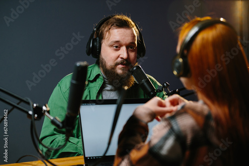 Radio presenters communicate live. The presenter and his guest have a conversation during the broadcast. © dsheremeta
