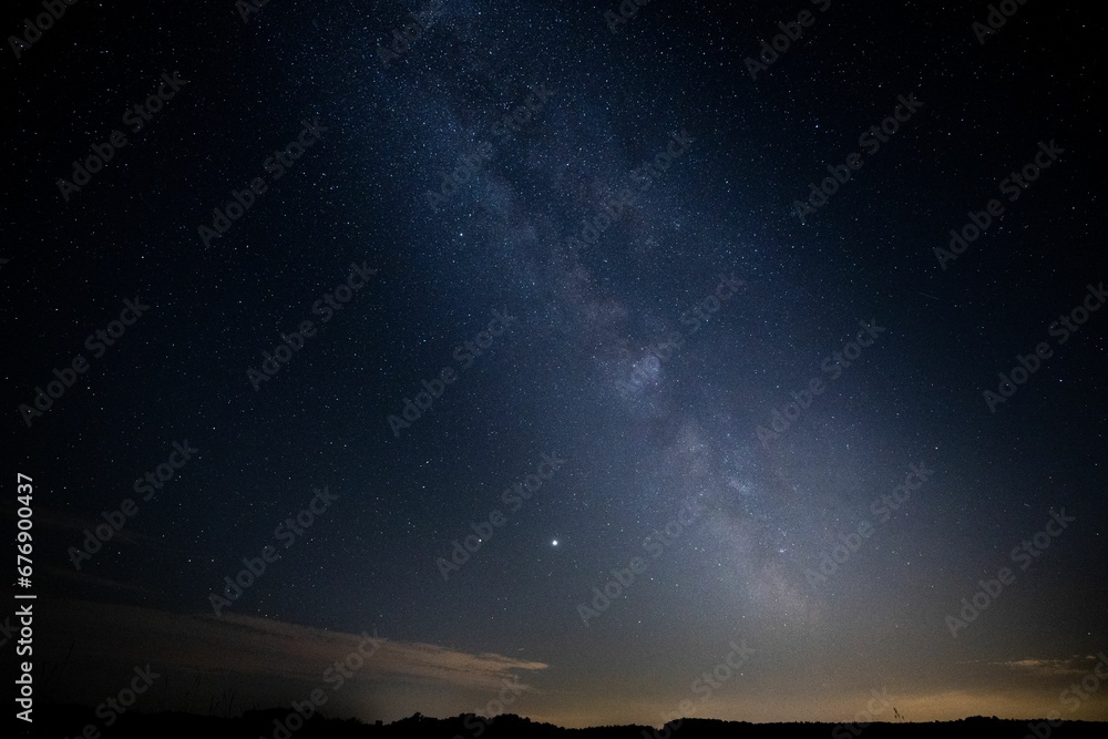 Breathtaking view of a starlit night sky, with the Milky Way, illuminated in all its majestic glory