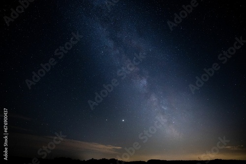 Breathtaking view of a starlit night sky, with the Milky Way, illuminated in all its majestic glory © Wirestock