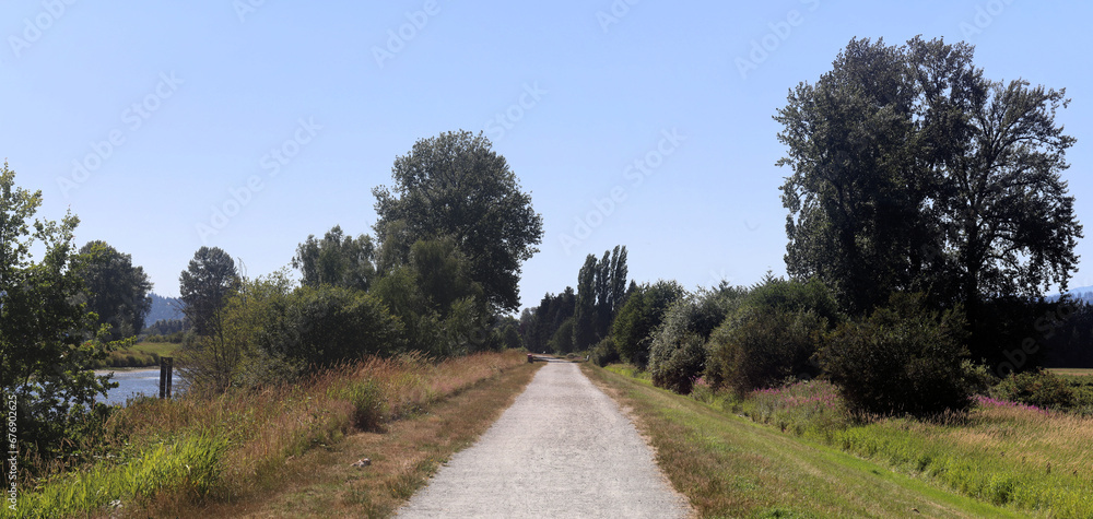 Gravel path of river dykes in sunny day Gravel path of river dykes in sunny day
