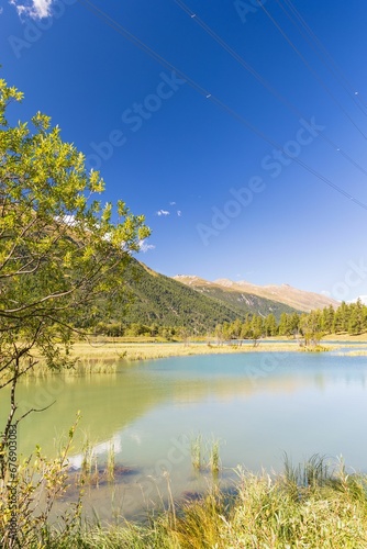 Blue sky over the lake with forested hills background