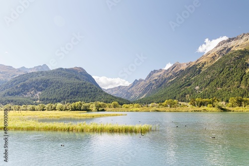 Blue sky over the lake with forested hills background