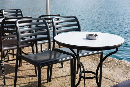 Modern restaurant terrace. Outdoor restaurant at the beach with pair of chair. Table setting at the beach restaurant