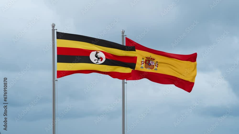 Spain and Uganda flag waving together on cloudy sky, endless seamless loop, two country cooperation concept Spain and Uganda flag waving together on cloudy sky, endless seamless loop, two country cooperation concept