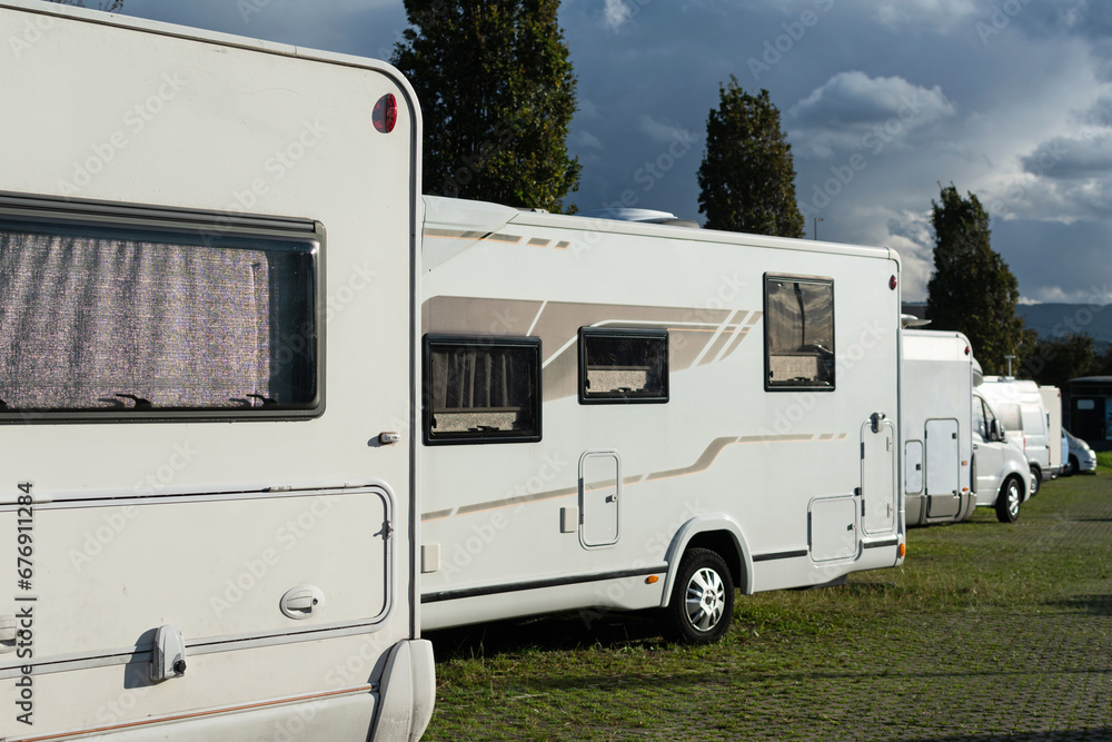 Naklejka premium Motorhome parking. Warm sun on a gray afternoon
