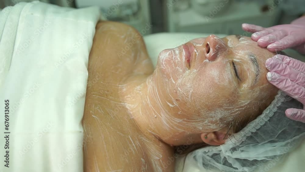 Woman with clean skin is preparing for a cosmetic procedure. Cleansing the face lady lying in a cosmetology room. Woman with clean skin is preparing for a cosmetic procedure. Cleansing the face lady lying in a cosmetology room.
