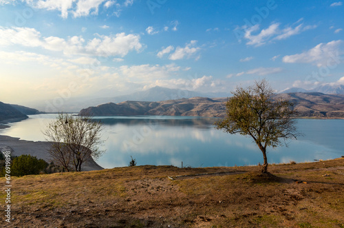 scenic view of Charvak reservoir and Tian Shan mountains in late autumn (Yusufhona, Tashkent region, Uzbekistan)