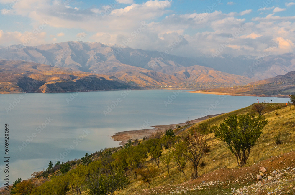 scenic view of Charvak reservoir and Tian Shan mountains in late autumn (Yusufhona, Tashkent region, Uzbekistan)