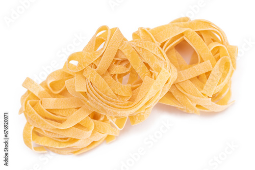 Three Classic Italian Raw Egg Fettuccine - Isolated on White Background. Dry Twisted Uncooked Pasta. Italian Culture and Cuisine. Raw Golden Macaroni Pattern - Isolation