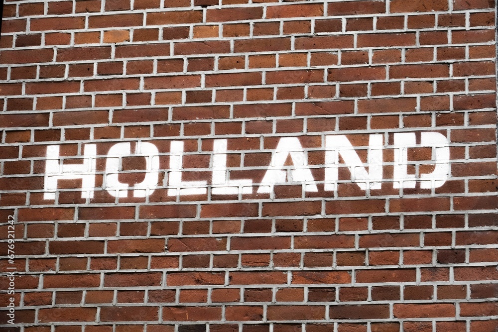 Word Holland spray painted on a brick wall Word Holland spray painted on a brick wall