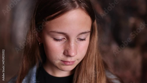 Portrait of a beautiful brunette young girl coughing and looking dramatically and suspiciously at camera
