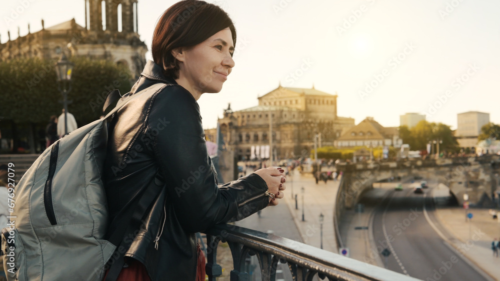 Obraz premium Young Woman Admires City View, With Blurred Cityscape In Autumn As Backdrop