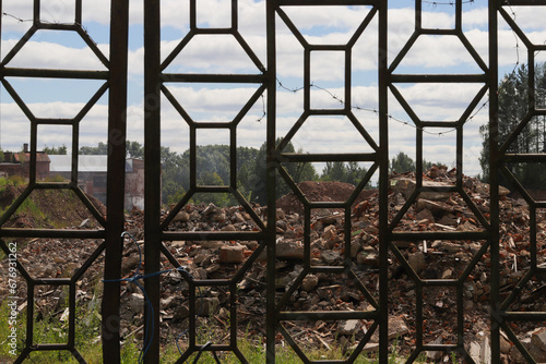 ruins of an industrial building behind a metal gate