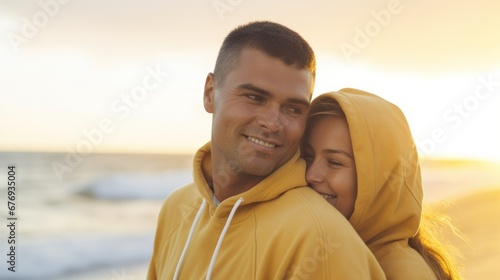 A couple hugging on a beach at sunset, expressing their love and enjoying the beautiful scenery.