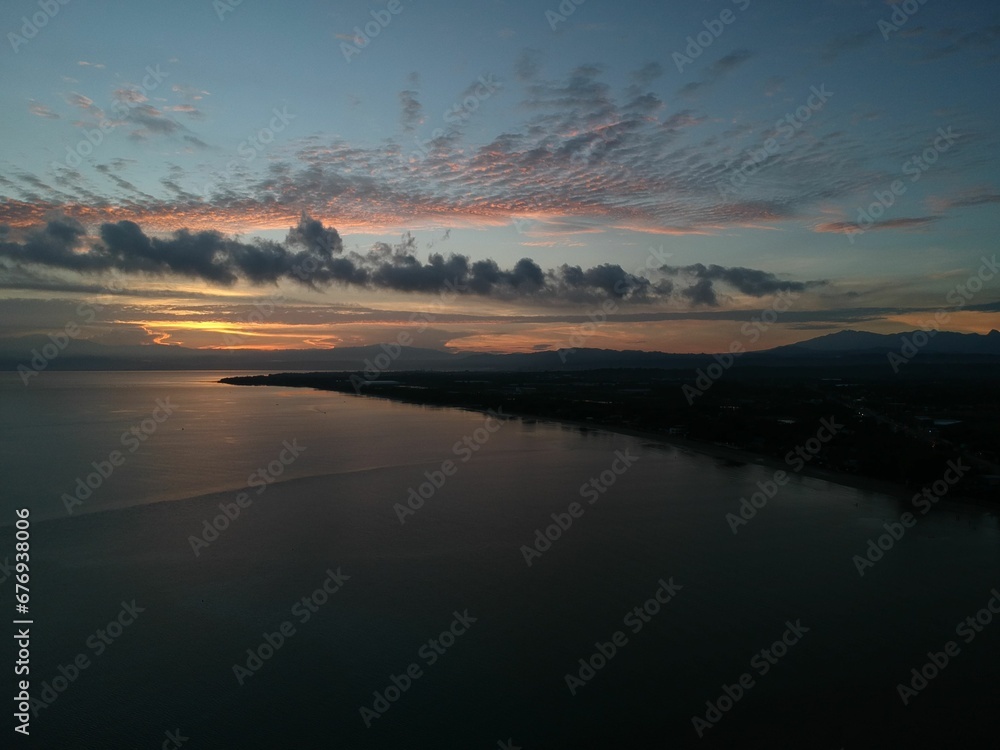 sunset over the ocean at dusk with the sun set in the distance sunset over the ocean at dusk with the sun set in the distance