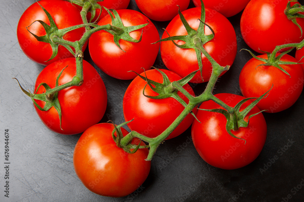 Above view studio shot of fresh tomatoes on black cutting board. Above view studio shot of fresh tomatoes on black cutting board.