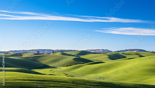 Expansive lush green fields and serene blue sky with fluffy clouds create a picturesque landscape
