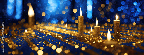 Candle golden lights blurred festive background, decorative blue shiny holiday card with copy space.