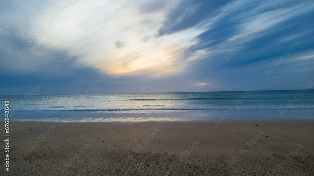 Calm beach shore under a bright blue sky in Tangier, Morocco