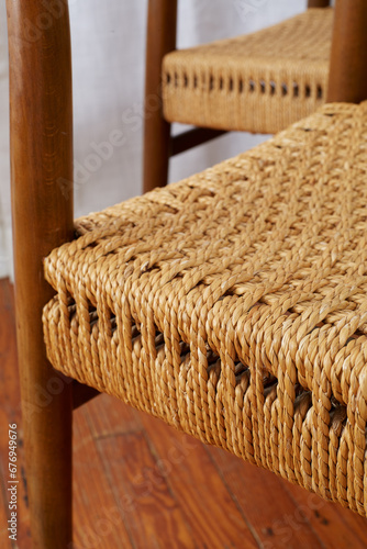 Close-up detail photograph of a vintage minimalist cord chair. Elegant Mid-Century Modern design. 