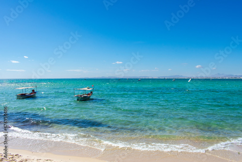 Hammamet Tunisia, Beach and  boats on shallow water, view on Mediterranean sea 