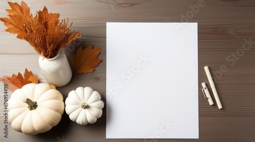 Empty white paper on a wooden table from top, flatlay, pumpkins and pale decoration