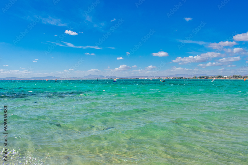Hammamet Tunisia, Beach and  boats on shallow water, view on Mediterranean sea 