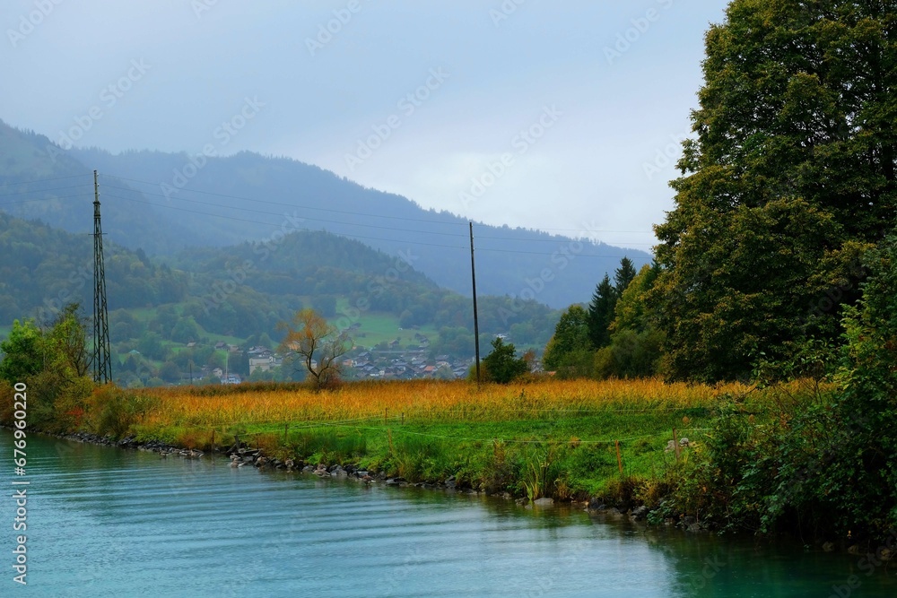 Obraz premium Landscape of a bay with trees and mountain, Switzerland 1