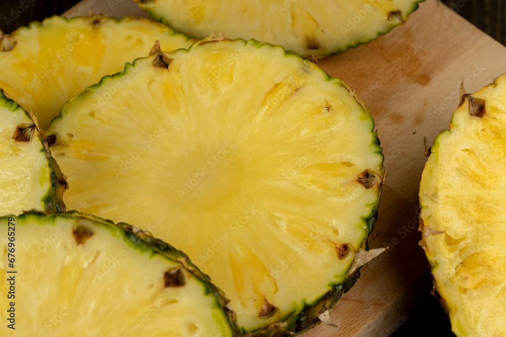 sliced ripe yellow pineapple, a large number of pieces sliced ripe yellow pineapple, a large number of pieces