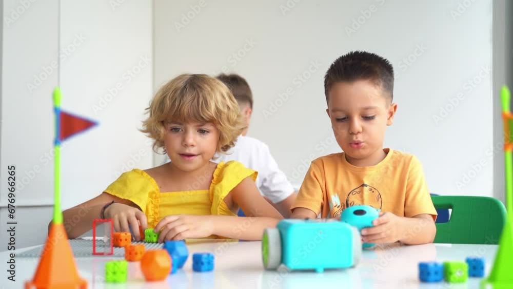Caucasian children relaxing enjoying hobby playing with toy car remote control point in white classroom . Preschoolers kids learning radio-controlled car. Caucasian children relaxing enjoying hobby playing with toy car remote control point in white classroom . Preschoolers kids learning radio-controlled car.