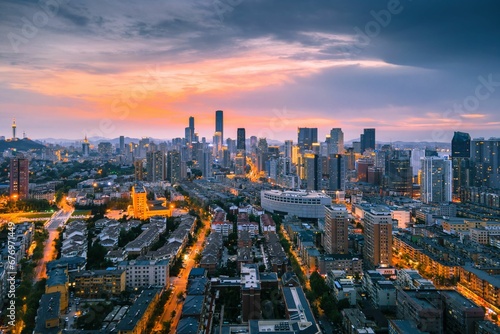 Fototapeta Naklejka Na Ścianę i Meble -  Aerial view of the stunning city skyline illuminated by the setting sun in Dalian, China