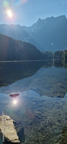  Nestled amid the picturesque landscapes of the Austrian Alps, Lake Piburg enchants with its crystal-clear waters and scenic surroundings. Surrounded by lush forests and majestic mountains, the lake r photo