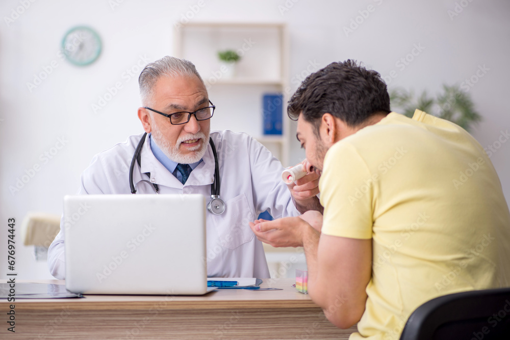 Young male patient visiting old male doctor