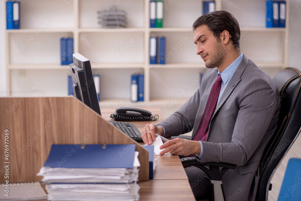 Young male employee working in the office