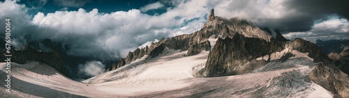 Panoramic shot of the dry rocky mountains reaching to the clouds, Aosta Valley, Italy