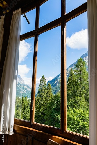 Vertical of a beautiful landscape with mountains and leafy trees captured from a window in Italy